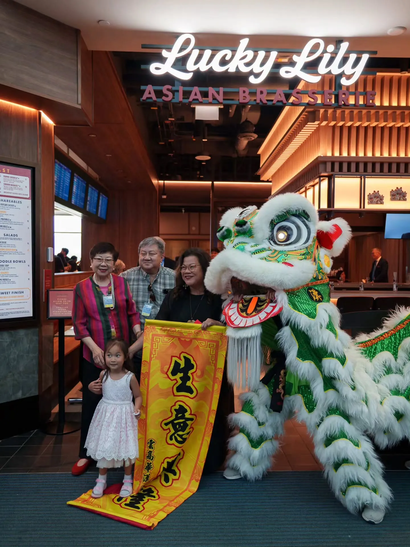 Lion dance and prosperity banner at a restaurant grand opening