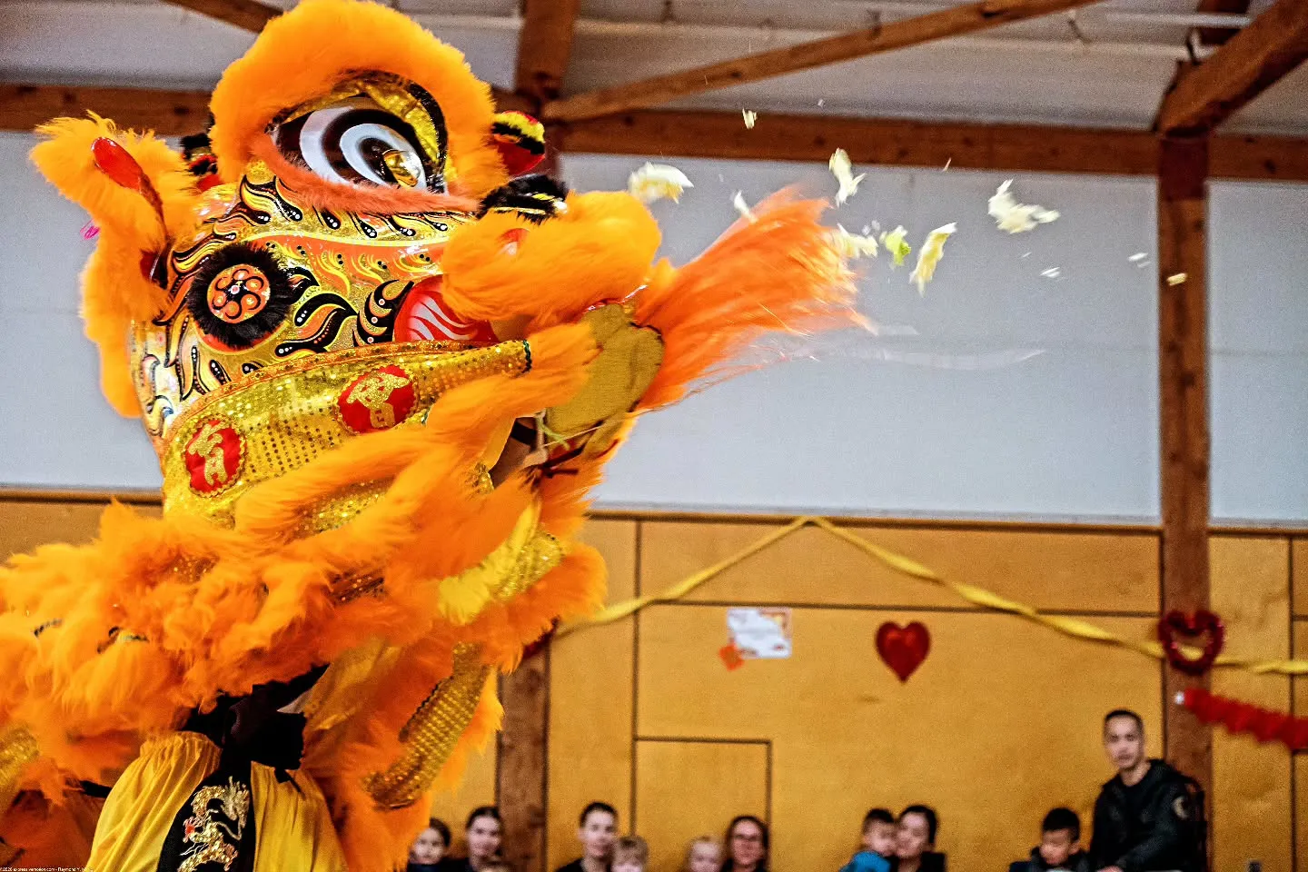 Lion tossing greens during a Choi Cheng prosperity ritual