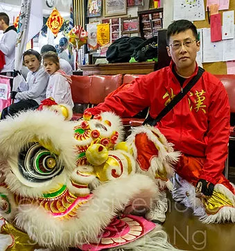 Raymond Ng with a lion dance head
