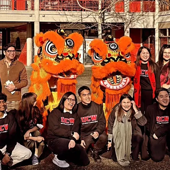 Twin lions with University Canada West students at a Lunar New Year blessing